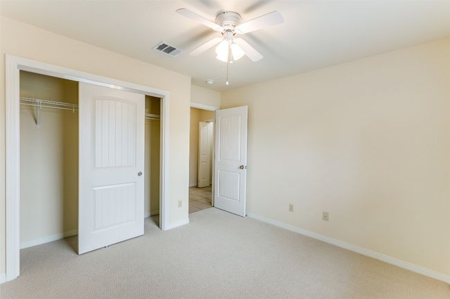 Unfurnished bedroom with light carpet, a closet, and a ceiling fan | Image 20