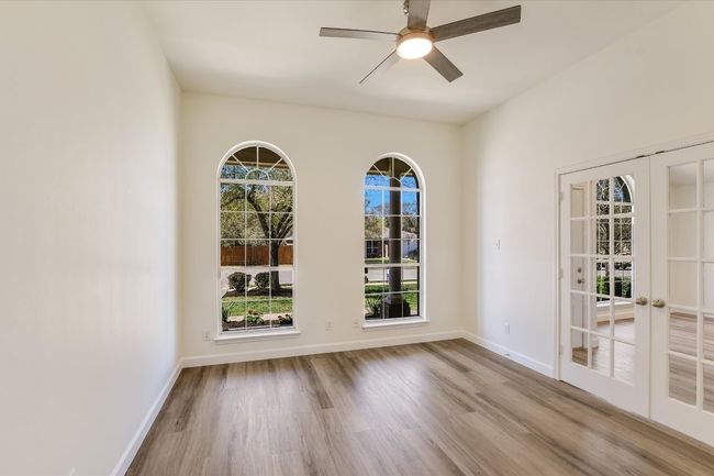 This home has a large separate office space with double glass doors and two windows for beautiful natural light. | Image 8