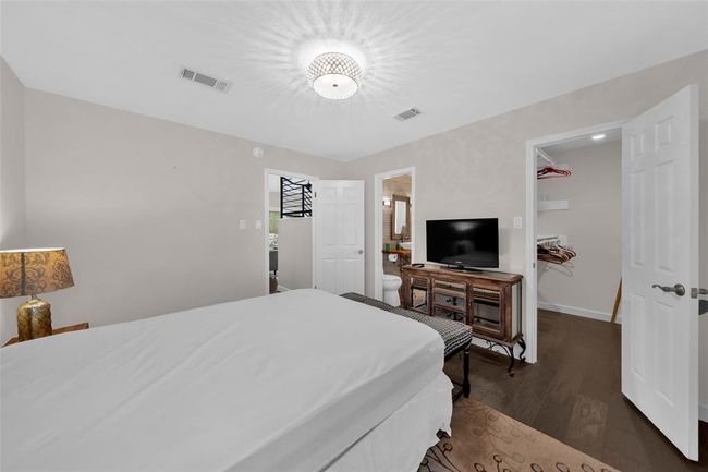 Bedroom with dark wood-style floors and baseboards | Image 11