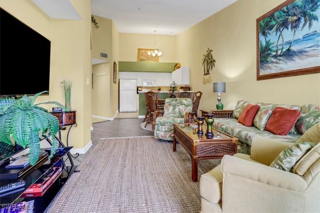 Living room featuring a chandelier and wood finished floors | Image 6