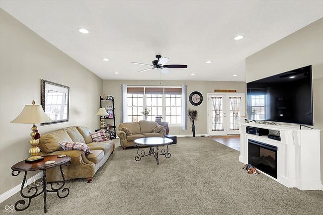 Great room has an electric fireplace on the right. | Image 8