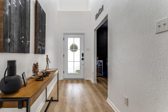 Entryway featuring light wood-style flooring and a textured wall | Image 4
