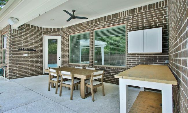 The spacious covered patio offers a built-in cabinet and a ceiling fan for comfortable outdoor living. | Image 35