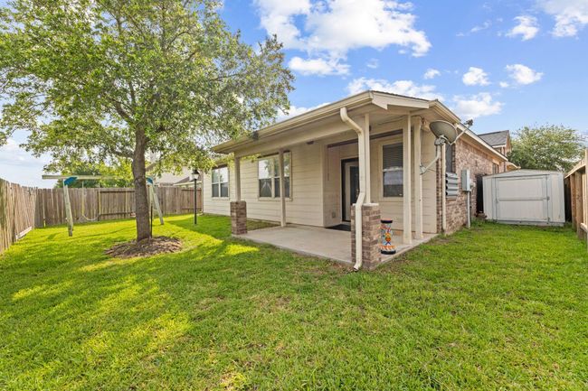 Backyard comes with covered patio area and a Tuff shed for additional storage | Image 39
