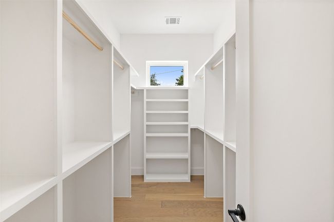 Walk in closet featuring light wood-style floors | Image 20