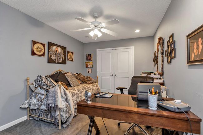 Home office featuring a textured ceiling, baseboards, a ceiling fan, and carpet floors | Image 15