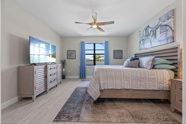 Bedroom with light wood finished floors, a ceiling fan, and baseboards | Image 19