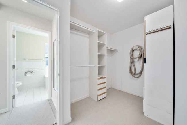 Spacious closet featuring light carpet | Image 21