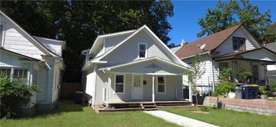 View of front of property featuring a front yard and covered porch | Image 1