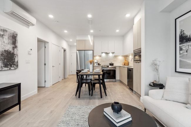 Living room featuring an AC wall unit, recessed lighting, baseboards, and light wood-type flooring | Image 6