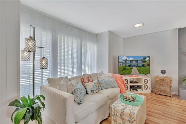 Lots and lots of windows make this home feel bright and happy. | Image 7