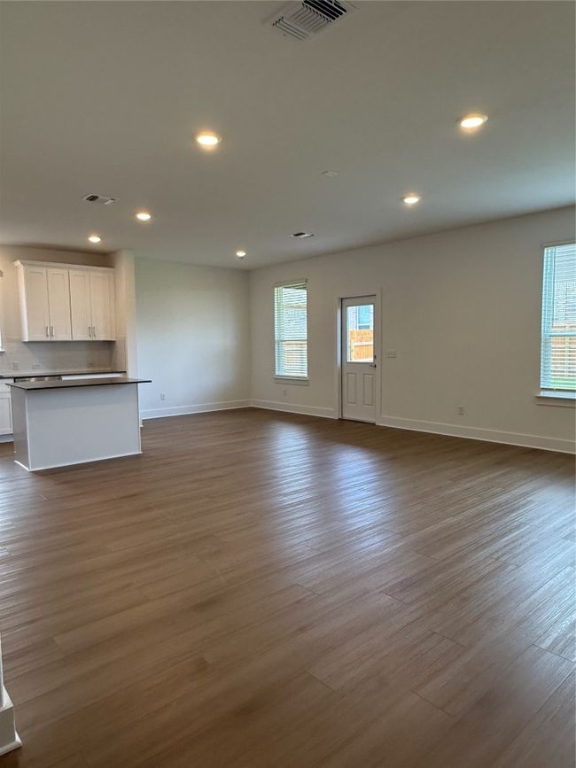Unfurnished living room with recessed lighting, baseboards, and dark wood-type flooring | Image 13