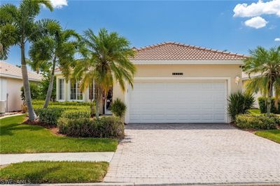 Mediterranean / spanish home featuring a garage | Image 1