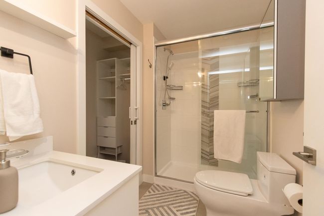 Full bathroom featuring toilet, vanity, and a shower stall | Image 13