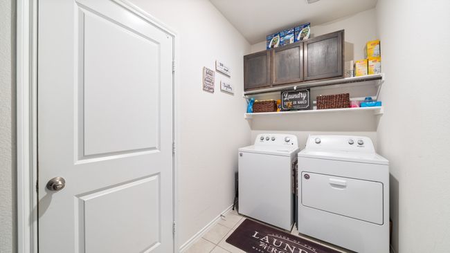 Washroom with separate washer and dryer, cabinet space, and light tile patterned flooring | Image 9