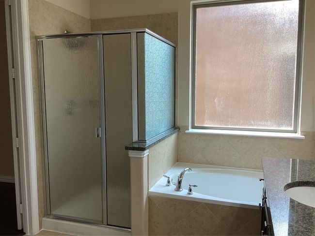Bathroom featuring a shower stall, a bath, and vanity | Image 15