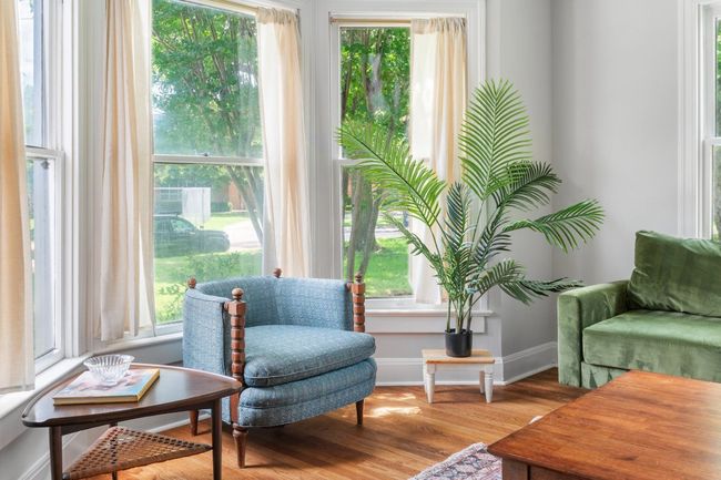 Bay windows in living area overlook Avenue C | Image 4