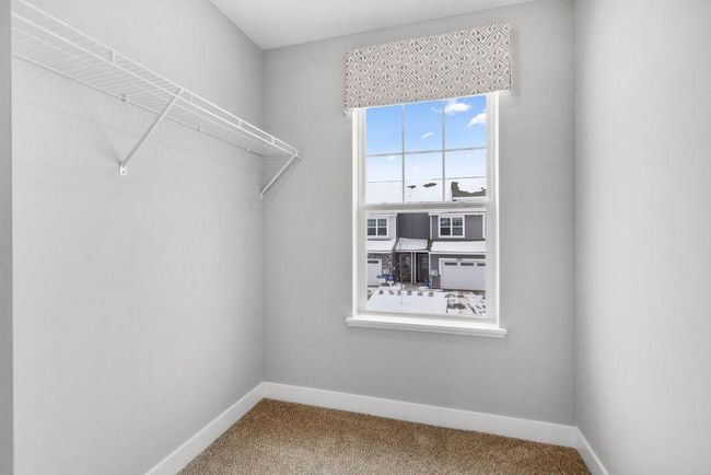 Bedroom 2 gets it's own large walk-in closet with a window! Photo is of model home. Colors and options may vary. Ask Sales Agent for details. | Image 29