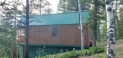 Side view of cabin and closed in storage underneath | Image 3