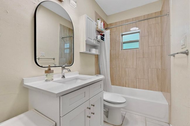 Full bath featuring vanity, shower / bath combo, and tile patterned floors | Image 19