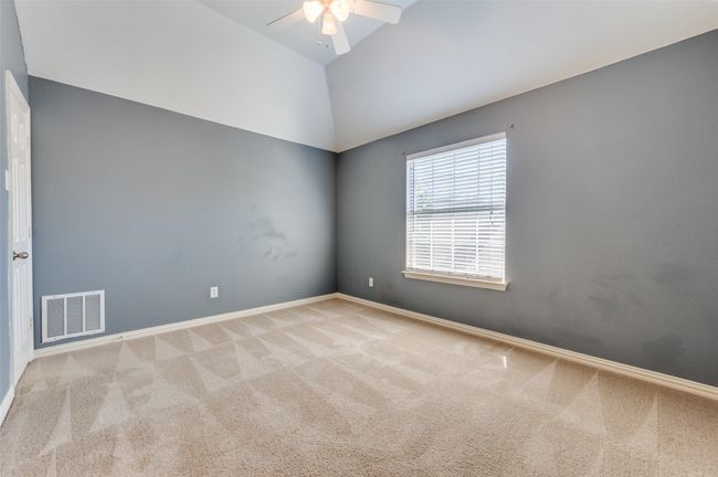 Carpeted empty room with a ceiling fan and vaulted ceiling | Image 17