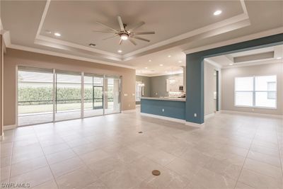 They call it a great room for a reason.....see for yourself! It includes select porcelain floors throughout all the home (except bedrooms), loads of windows and sliders to draw in light, and a gourmet kitchen that is convenient to your guests when entertaining. | Image 3