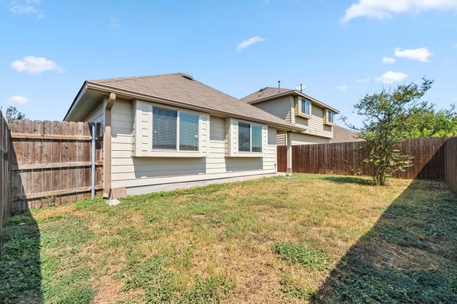 Rear view of property featuring a fenced backyard. | Image 31