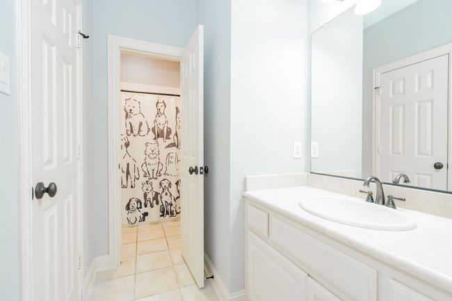 Full bathroom with vanity, baseboards, and tile patterned flooring | Image 25
