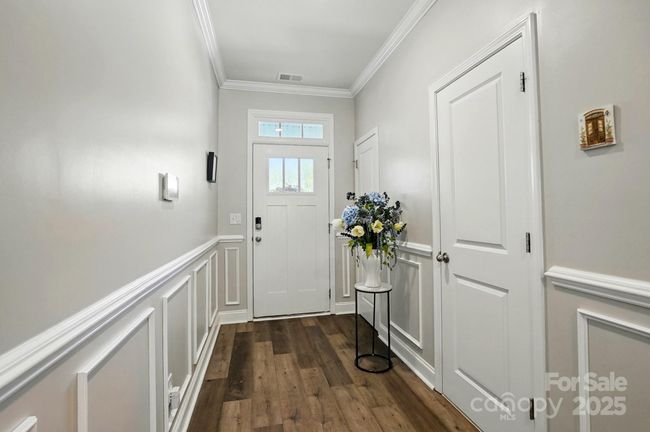 The owner has upgraded the flooring, paint, and added extra trim and moldings recently. | Image 5
