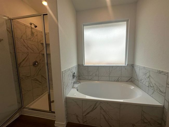 Bathroom with a shower stall and a bath | Image 31