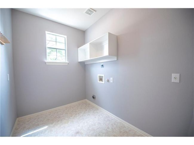 Laundry room featuring hookup for an electric dryer, washer hookup, and baseboards | Image 21