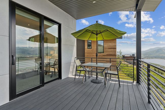 Wooden deck with a water and mountain view | Image 47