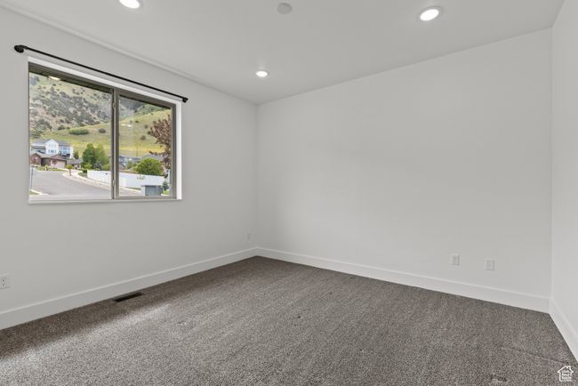 Carpeted spare room featuring recessed lighting and baseboards | Image 21
