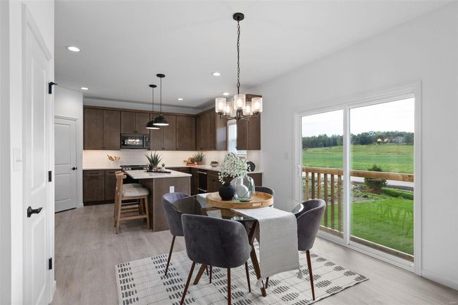 Dining space with light wood-type flooring and a chandelier | Image 8