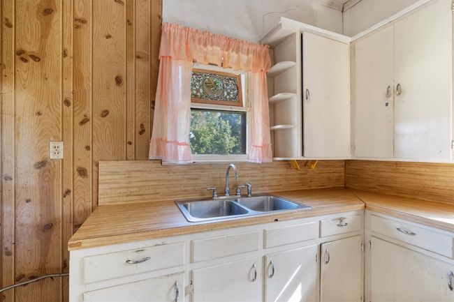 Kitchen featuring a sink and open shelves | Image 11