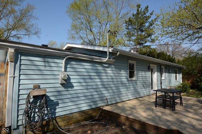 exterior space with outdoor dining space, a chimney, and a deck | Image 46