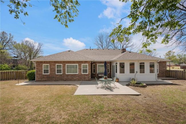 Rear view of property featuring a patio, a yard, fence, and brick siding | Image 42