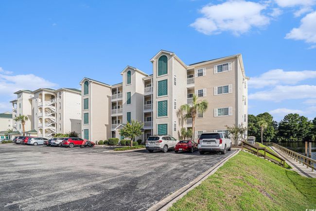 View of apartment building / complex with uncovered parking | Image 22