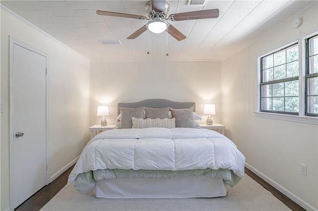 Bedroom featuring ceiling fan, hardwood / wood-style flooring, and crown molding | Image 33