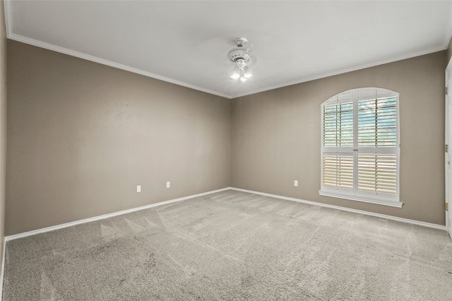 Carpeted spare room featuring crown molding | Image 18