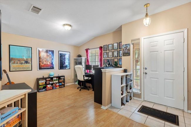 Office featuring vaulted ceiling, light wood-type flooring, and baseboards | Image 6