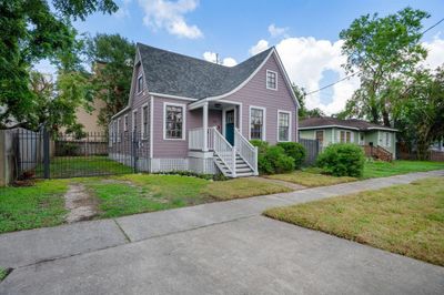 Cute front porch with a catslide roof, off street parking and on a quiet street - less car / pedestrian traffic! Long driveway for plenty of cars. LARGE backyard for parties and pets. Or build an addition onto the home or a garage for the vehicles! So many options! | Image 2