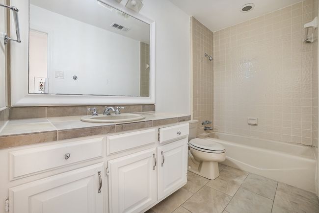 Bathroom with vanity, tile patterned flooring, shower / tub combination, toilet, and visible vents | Image 16