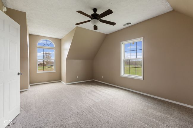bonus room with visible vents, baseboards, ceiling fan, carpet flooring, and lofted ceiling | Image 18