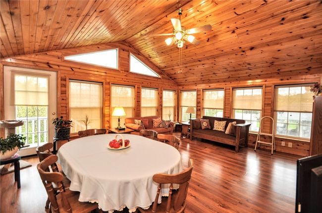This sunroom is so nice and bright, and huge! look at all of those windows! | Image 26