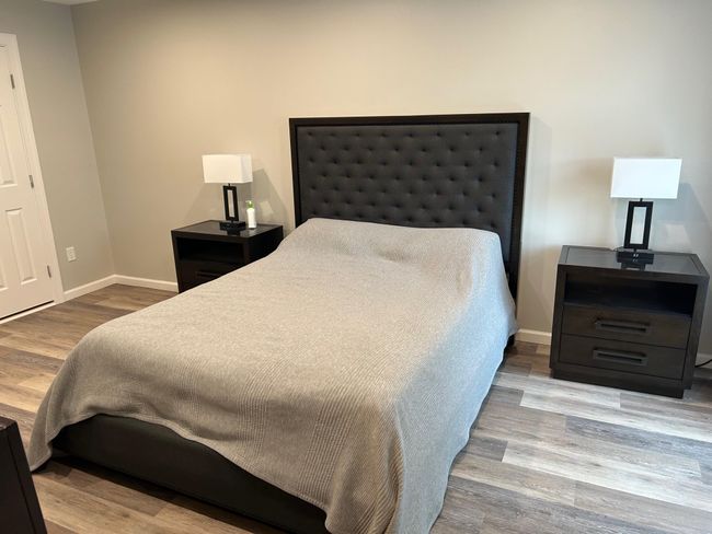 Bedroom with wood finished floors and baseboards | Image 32