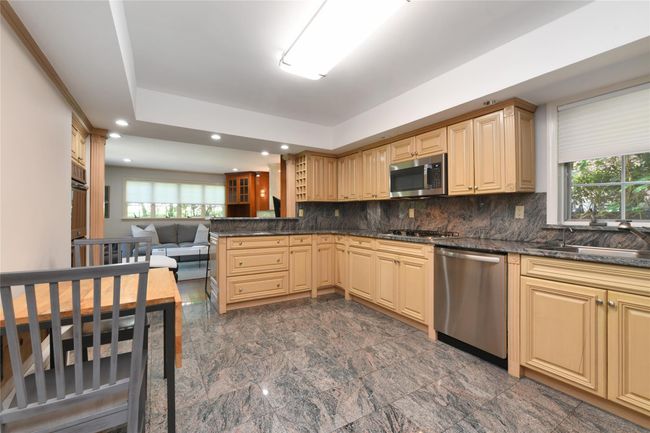 Kitchen featuring a sink, a peninsula, recessed lighting, backsplash, and appliances with stainless steel finishes | Image 5