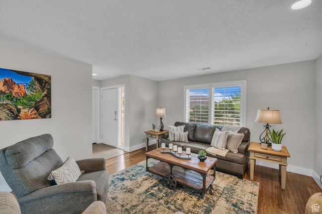 Living room featuring baseboards, wood finished floors, and recessed lighting | Image 8