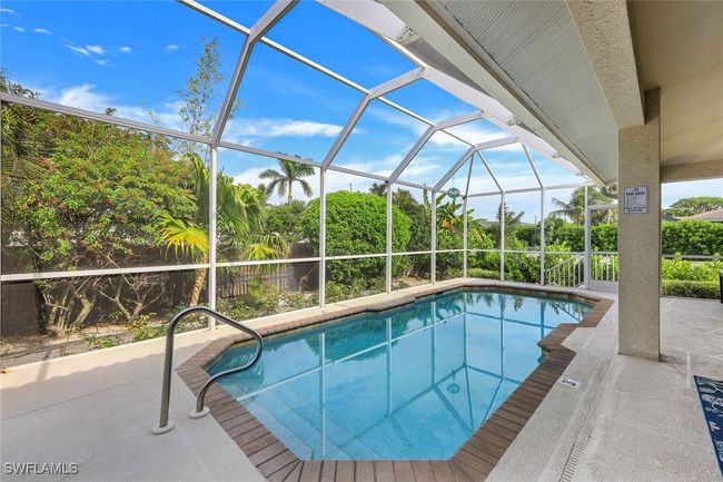 View of swimming pool with a patio area and glass enclosure | Image 23