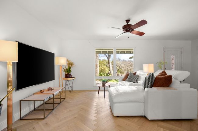 Living room featuring a ceiling fan and baseboards | Image 12